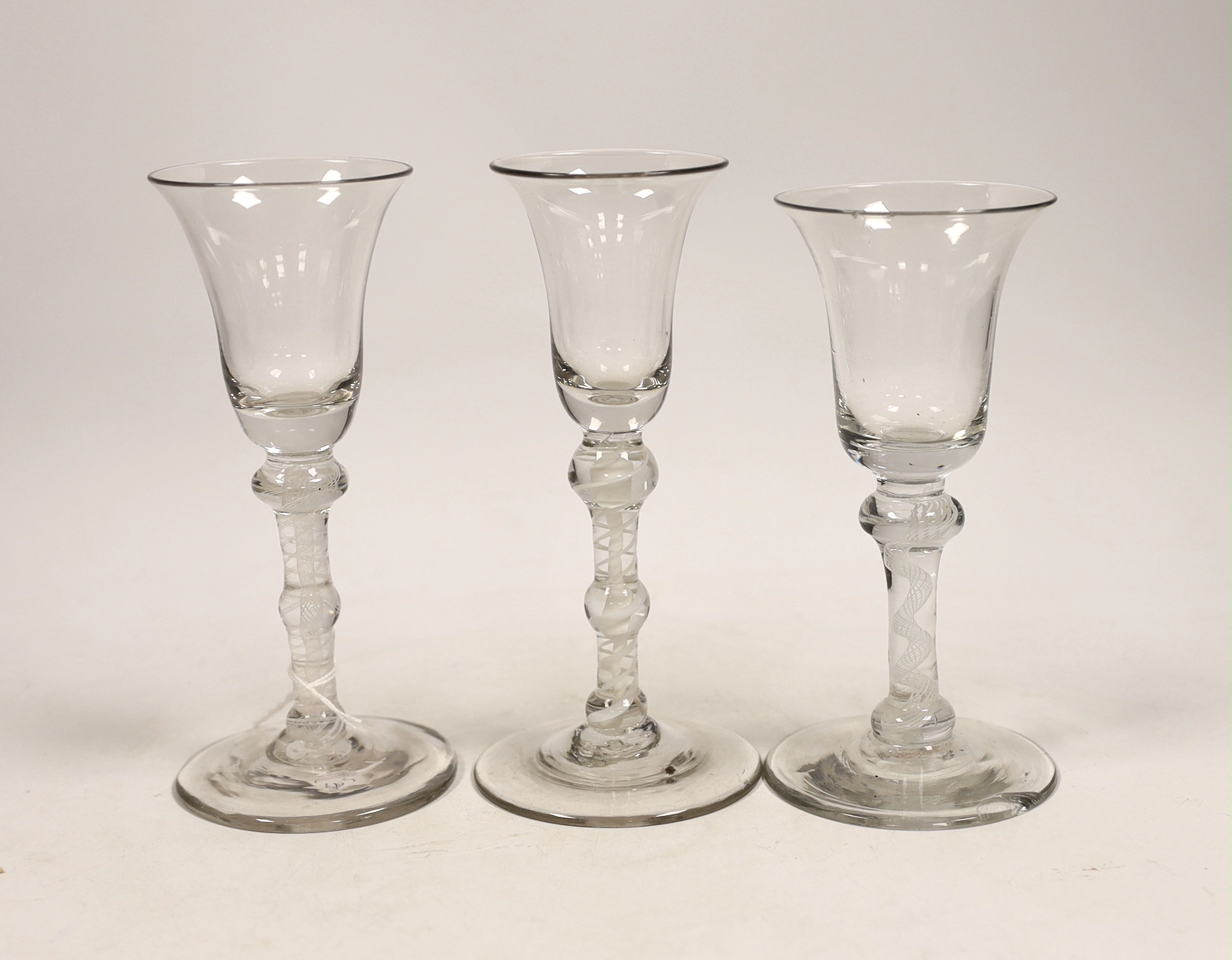 Three George III DSOT stem wine glasses, c.1760, largest 17cm high
